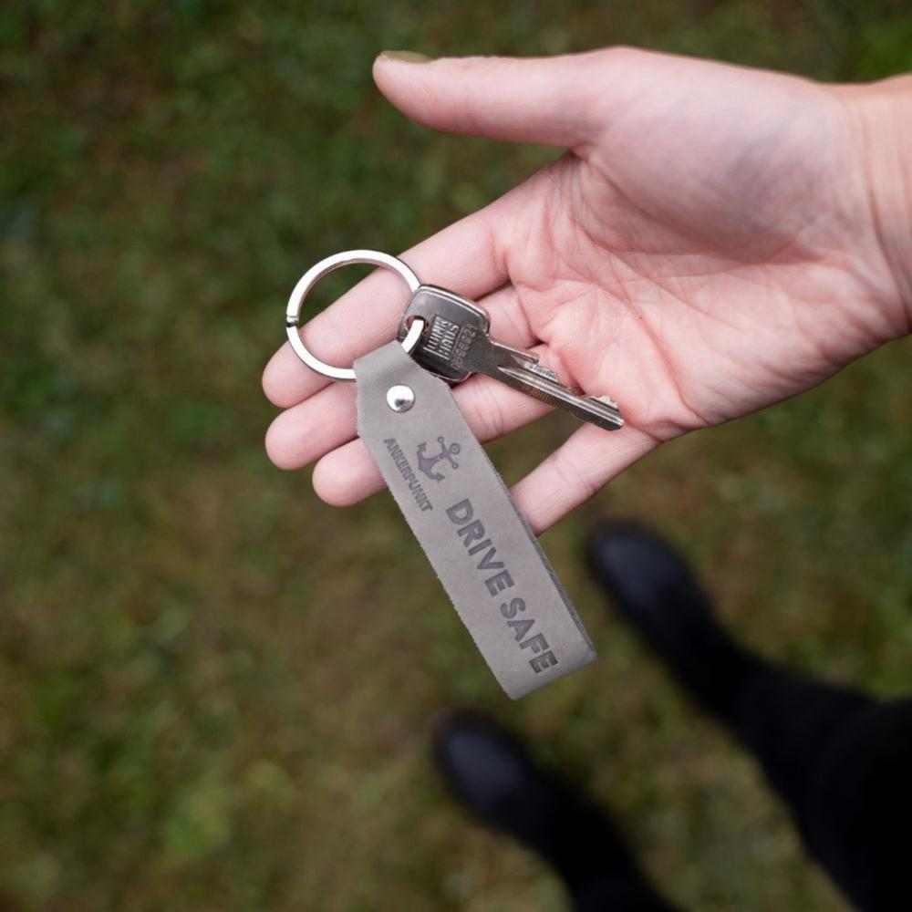 Gray leather "Drive Safe" keychain with keys, made in Germany.