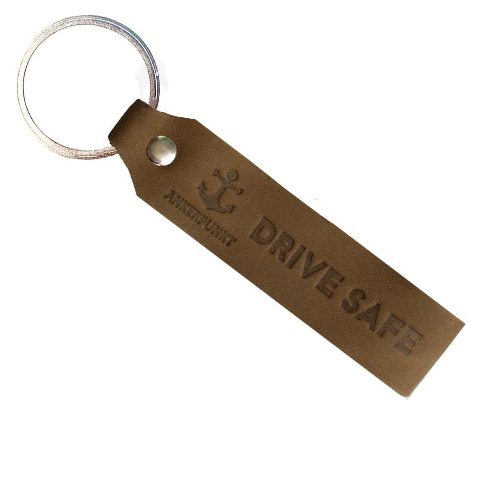 Dark brown leather "Drive Safe" keychain with round metal ring, eco-friendly, made in Germany.