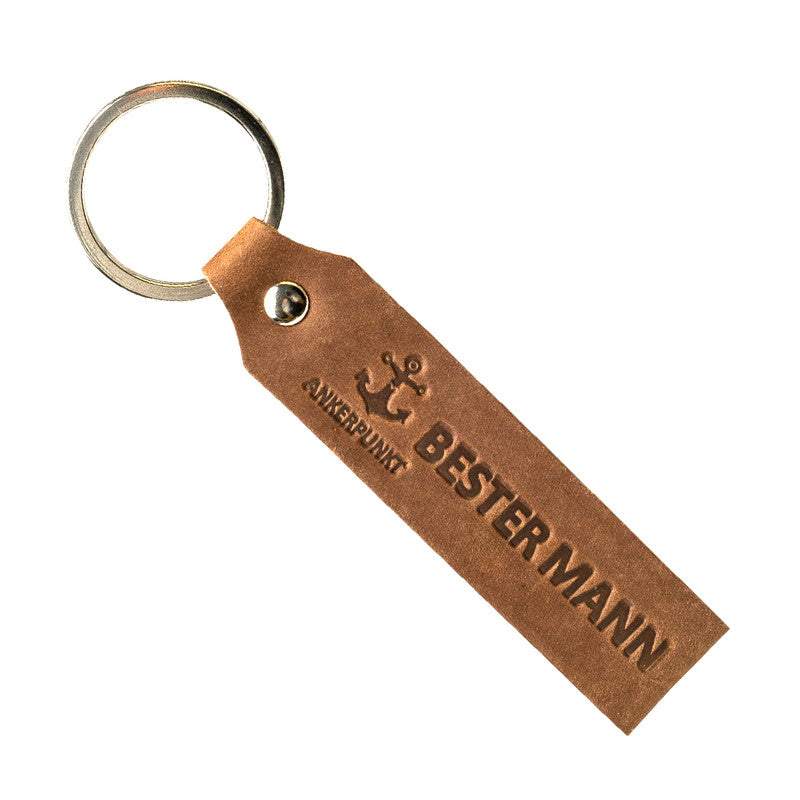 Dark brown leather keychain with "Bester Mann" engraving, made in Germany.