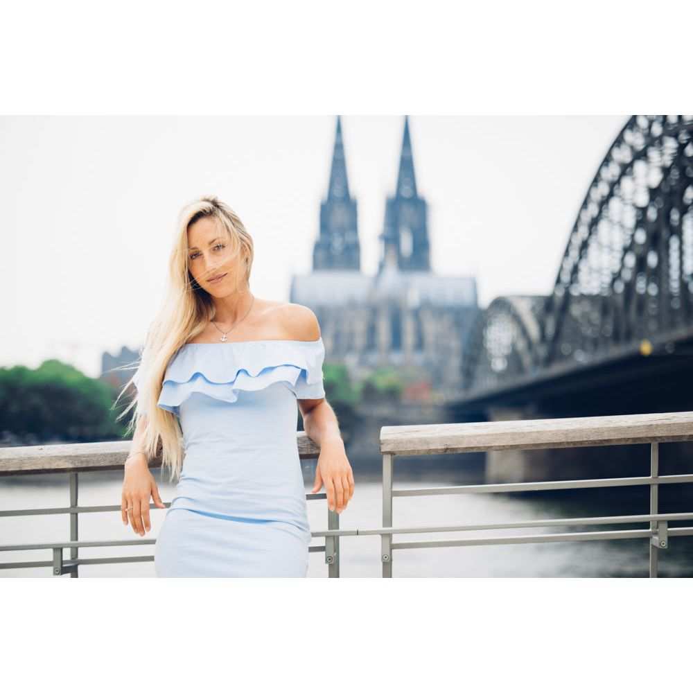 Silver anchor pendant necklace worn by woman near Cologne Cathedral.
