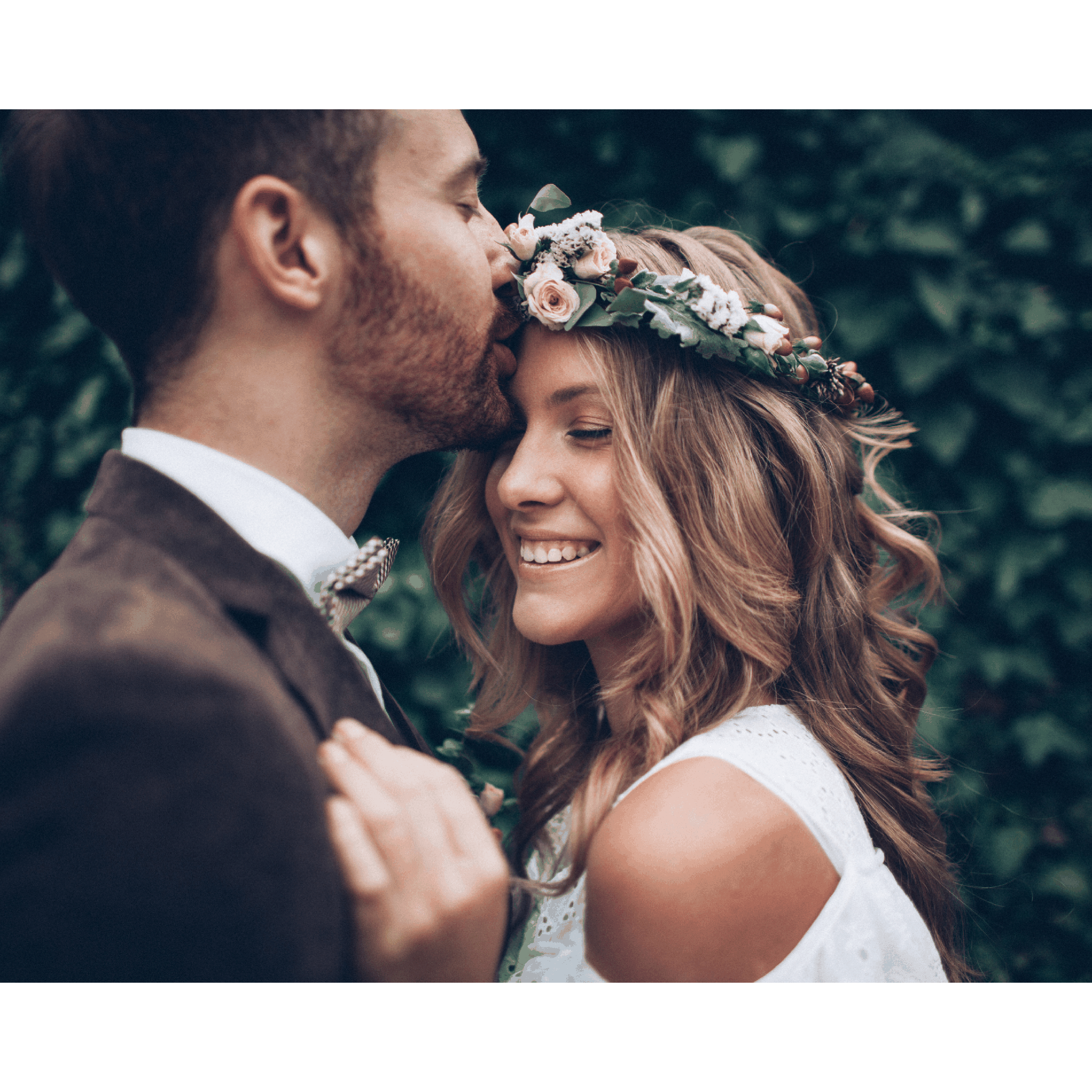 A smiling couple embraces outdoors, celebrating a special moment.