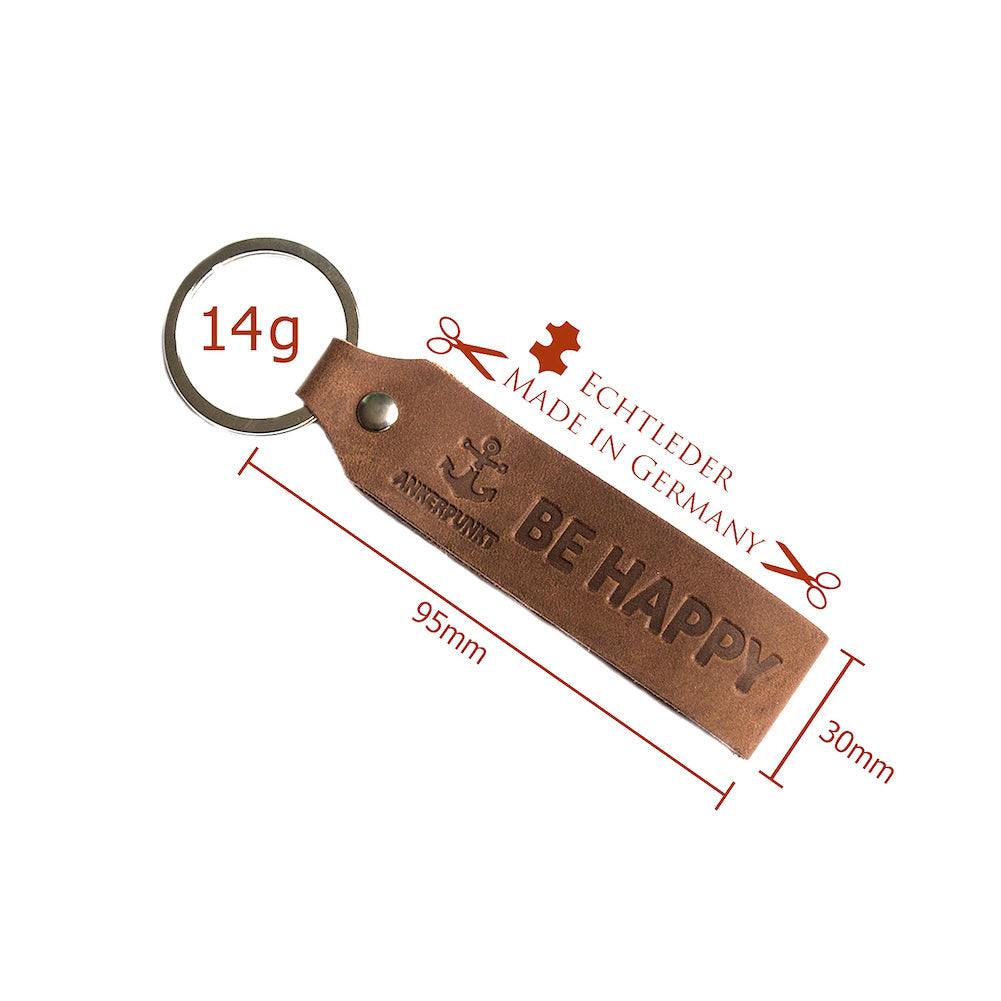 Dark brown leather keychain with "Be Happy" engraving, made in Germany, ANKERPUNKT branding.