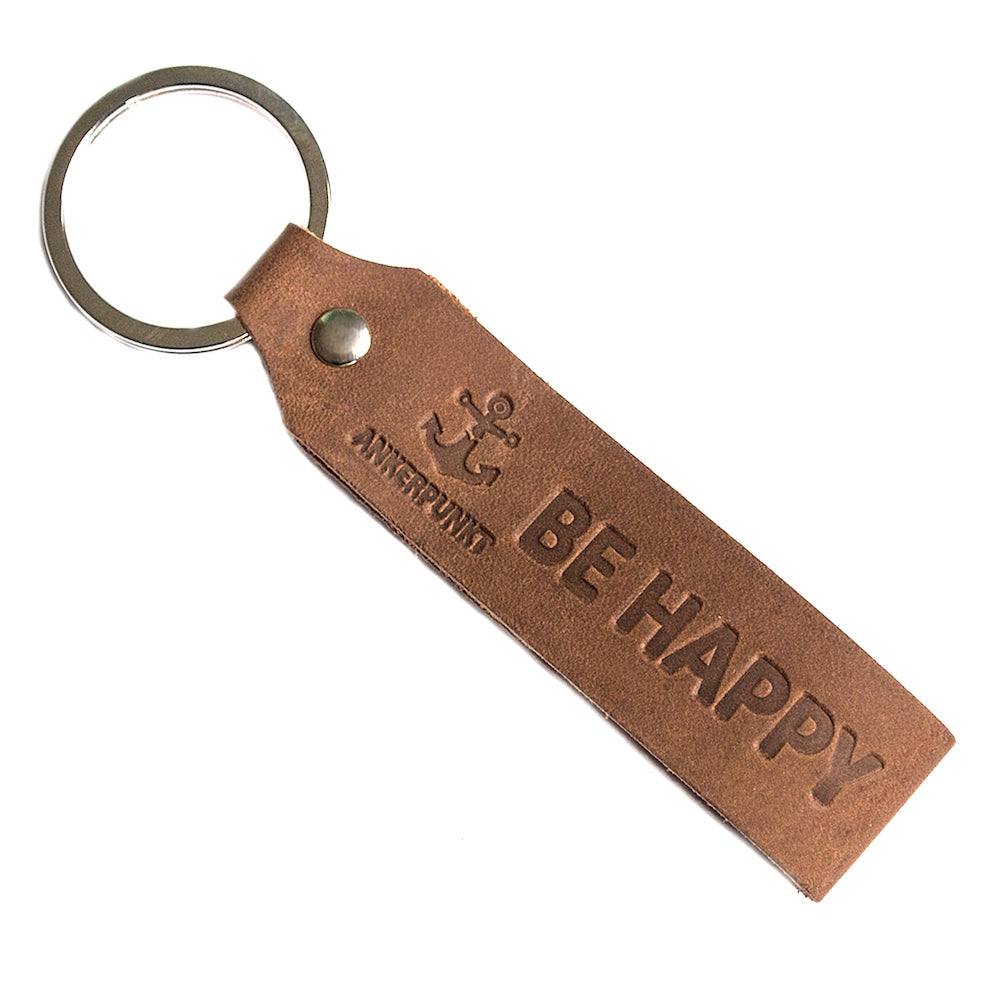 Leder Schlüsselanhänger mit Gravur "Be Happy" in dunkelbraun.